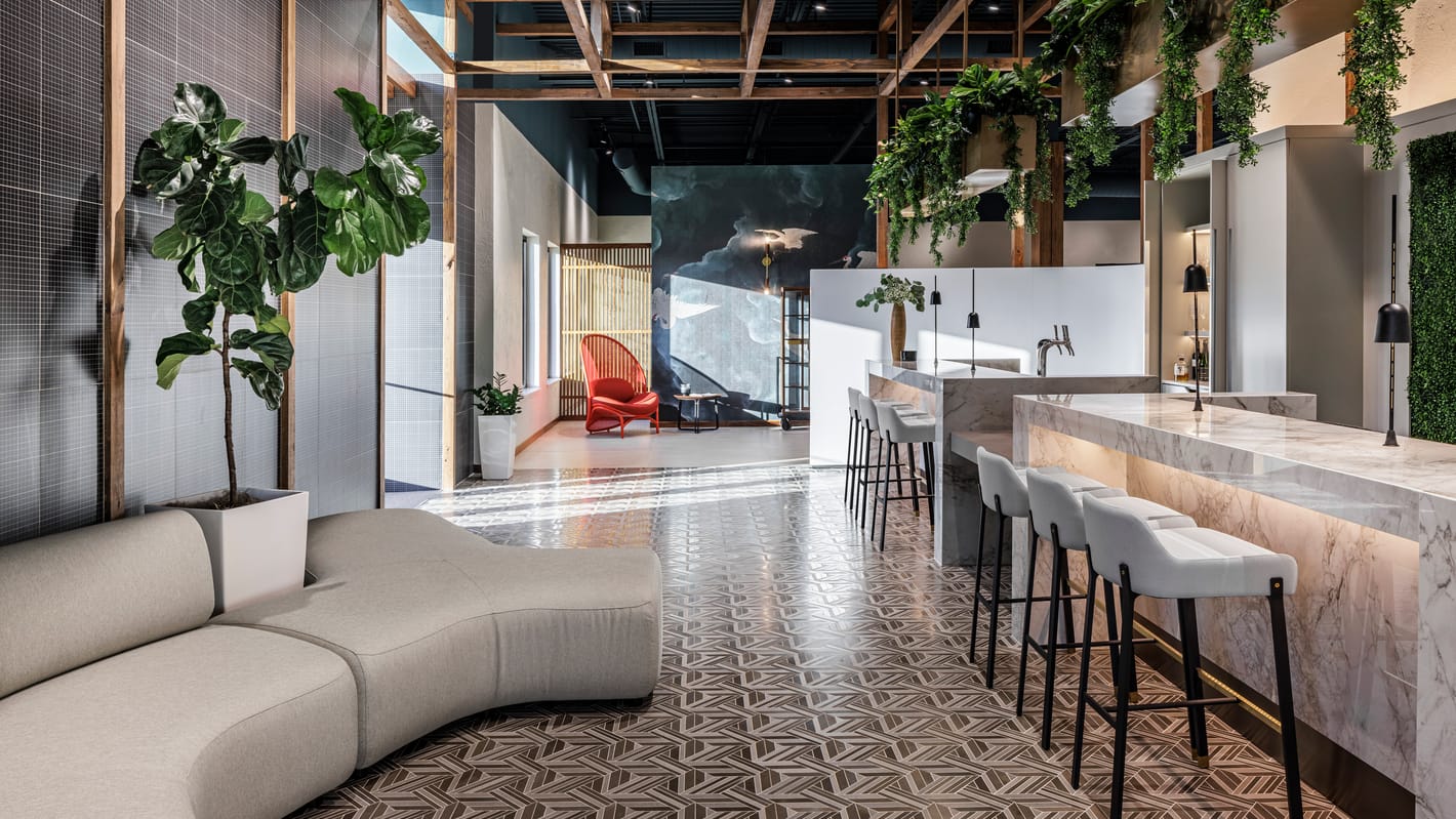Marble bar with hanging greenery, lounge seating, and patterned mosaic tile floors